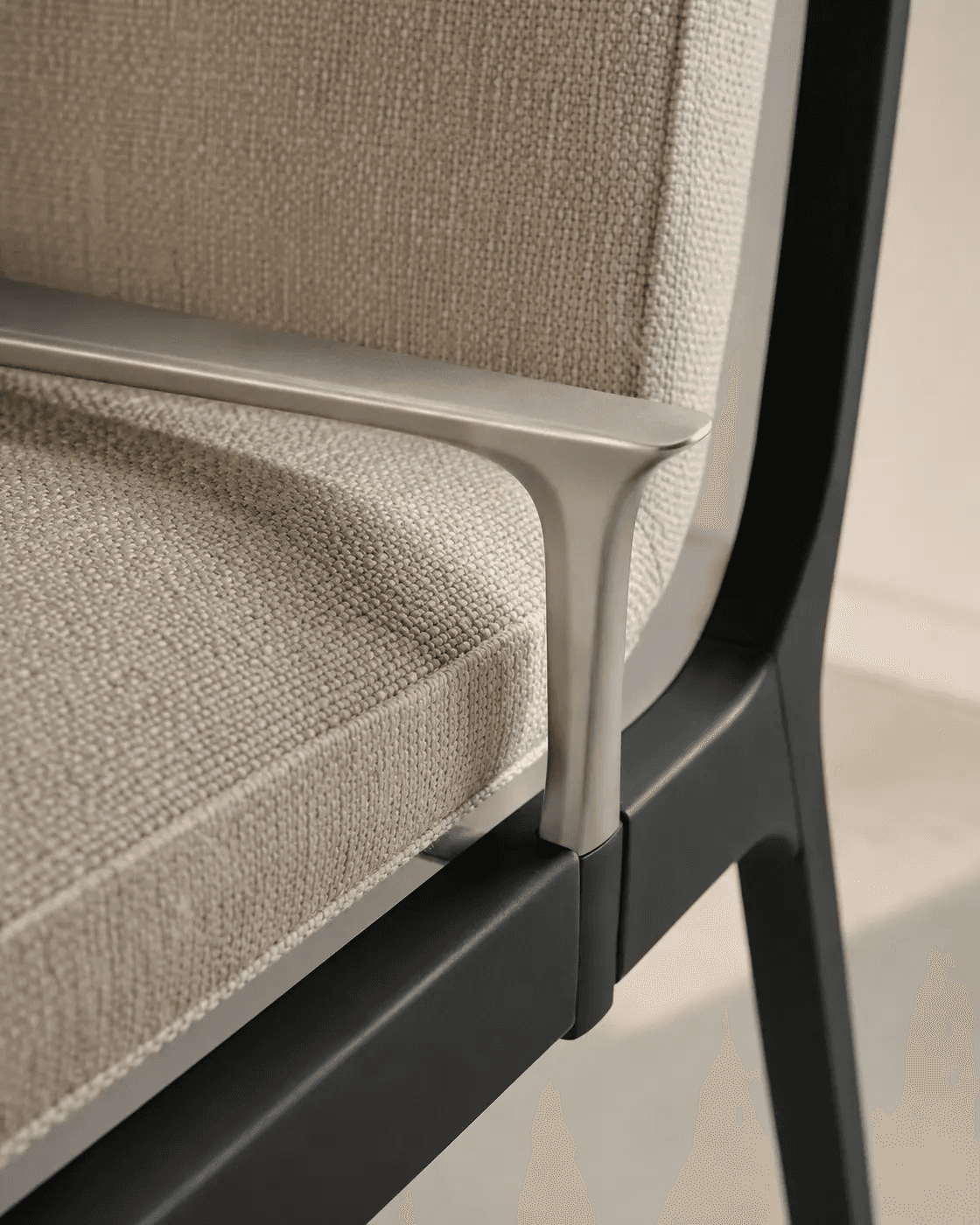 Close detail of upholstery, aluminum armrest and chair frame