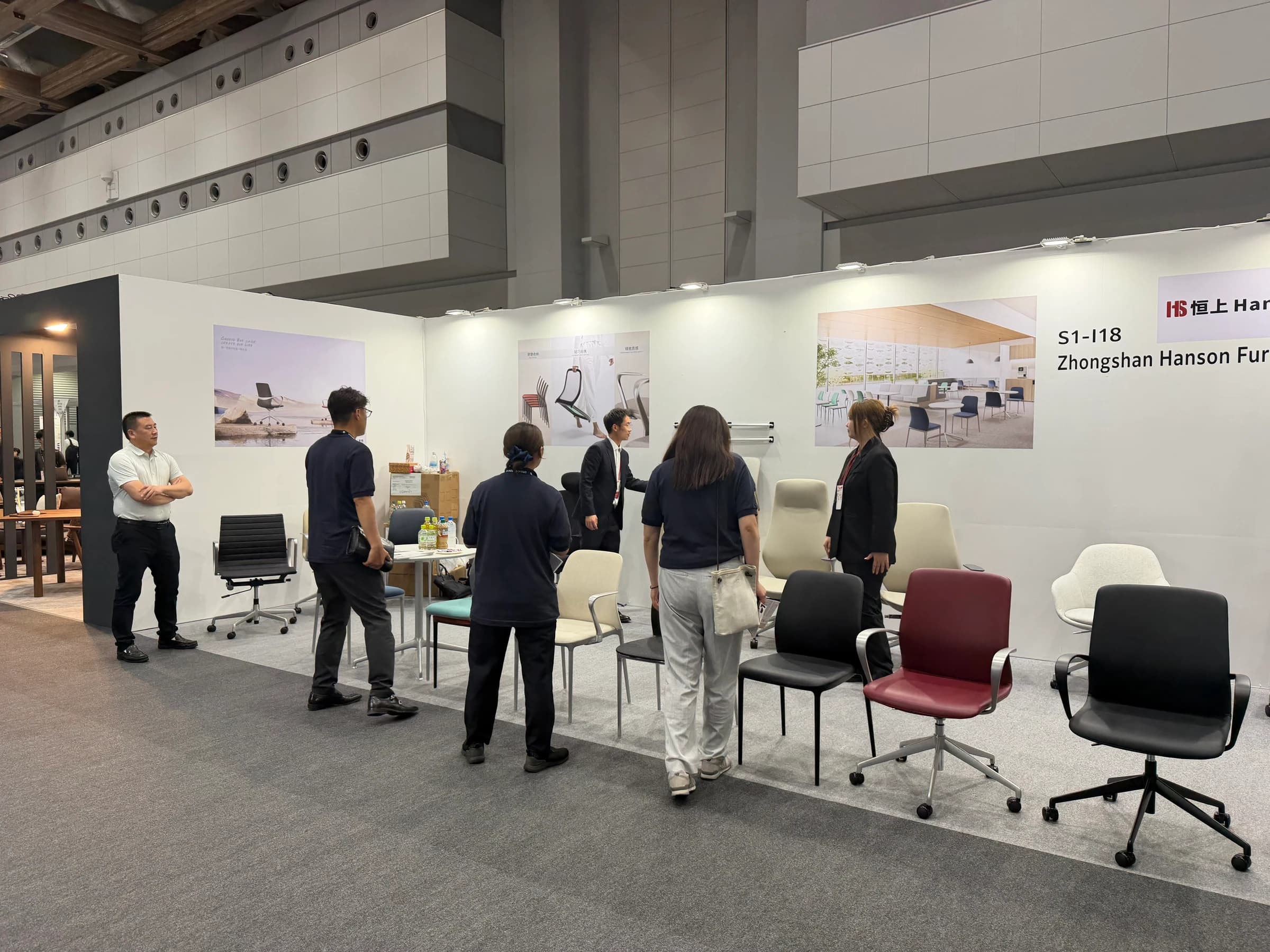 Visitors discussing seating with the Hanson Furniture team in Tokyo